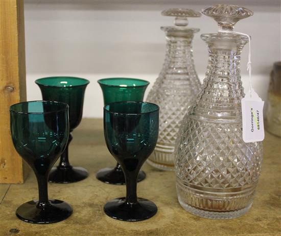Pair of cut glass decanters and four green glasses